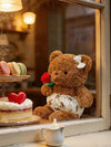24. Teddy Bear Wearing a Shirt Holding Flowers