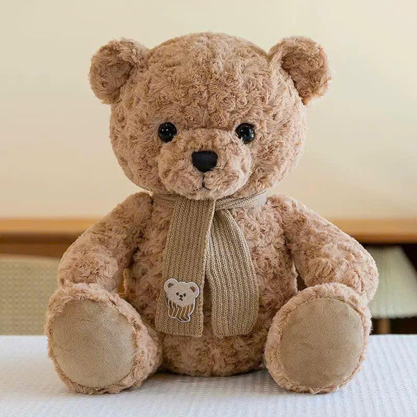 13. Bear Sits Wearing a Scarf