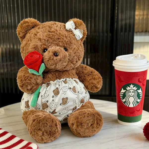 24. Teddy Bear Wearing a Shirt Holding Flowers