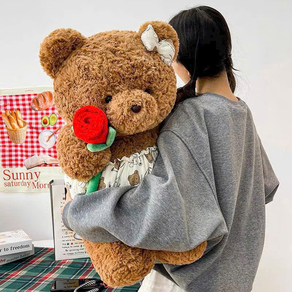24. Teddy Bear Wearing a Shirt Holding Flowers